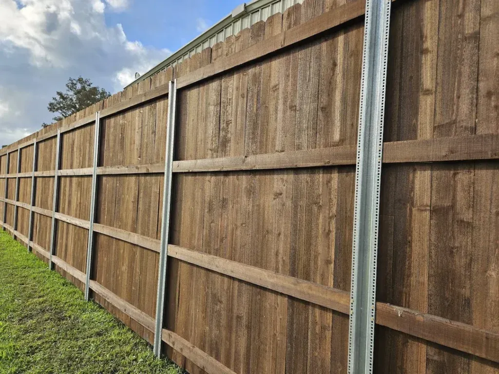 Stained wood privacy fence on PostMaster+ steel posts in Baton Rouge, LA